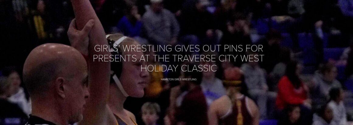 GIRLS’ WRESTLING GIVES OUT PINS FOR PRESENTS AT THE TRAVERSE CITY WEST HOLIDAY CLASSIC