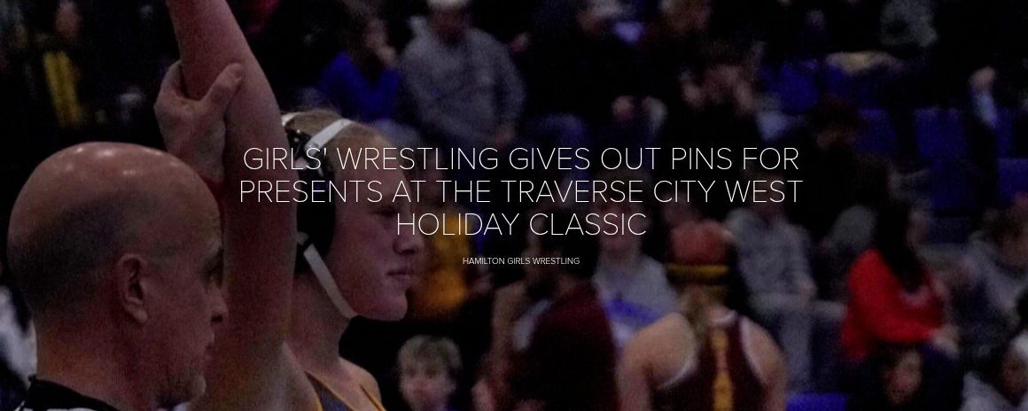 GIRLS’ WRESTLING GIVES OUT PINS FOR PRESENTS AT THE TRAVERSE CITY WEST HOLIDAY CLASSIC